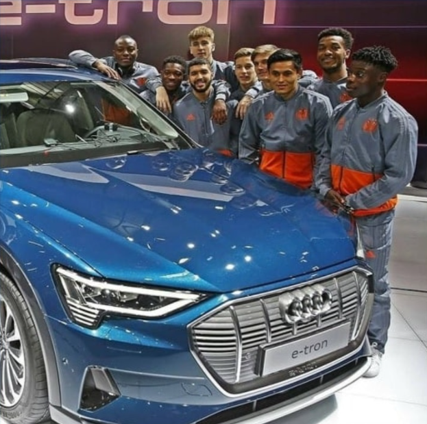 Jeremy Doku ao lado de seu carro Audi